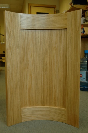 A curved shaker style kitchen door panel