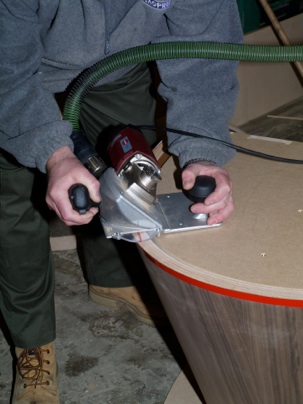 Trimming a conical boardroom table pedestal with a lipping planer